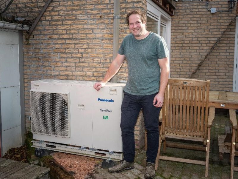 Jan-Willem Grachten staat voor de buitenunit van zijn warmtepomp